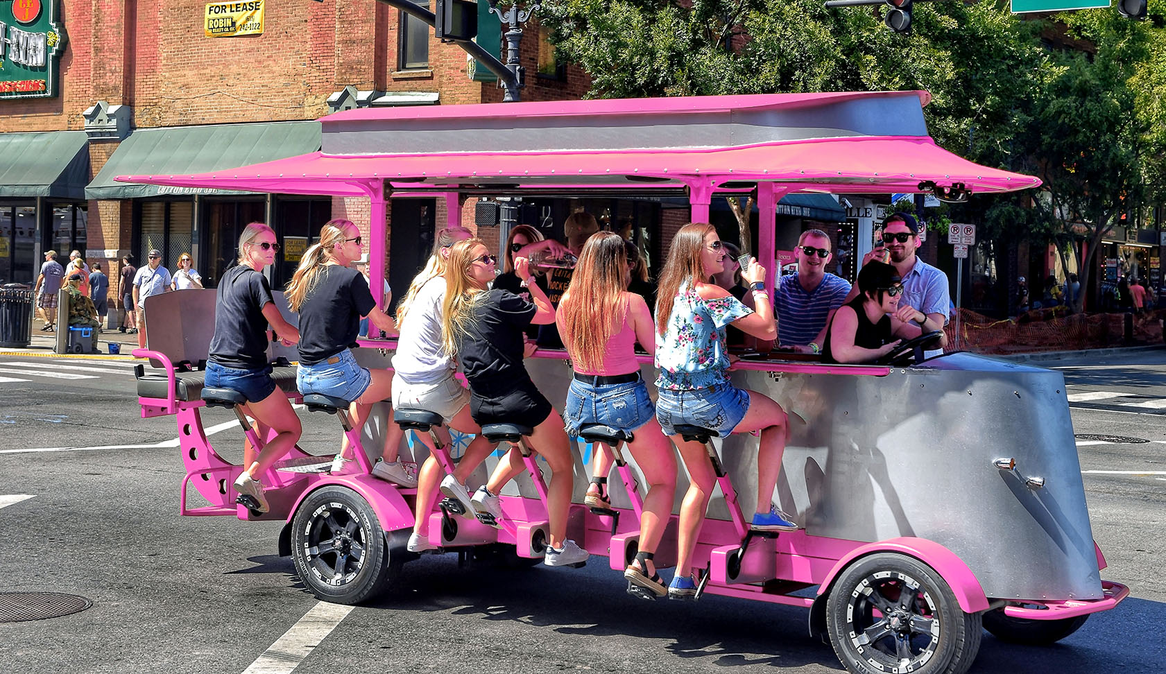 Pink party bike in Scottsdale being pedaled by passengers